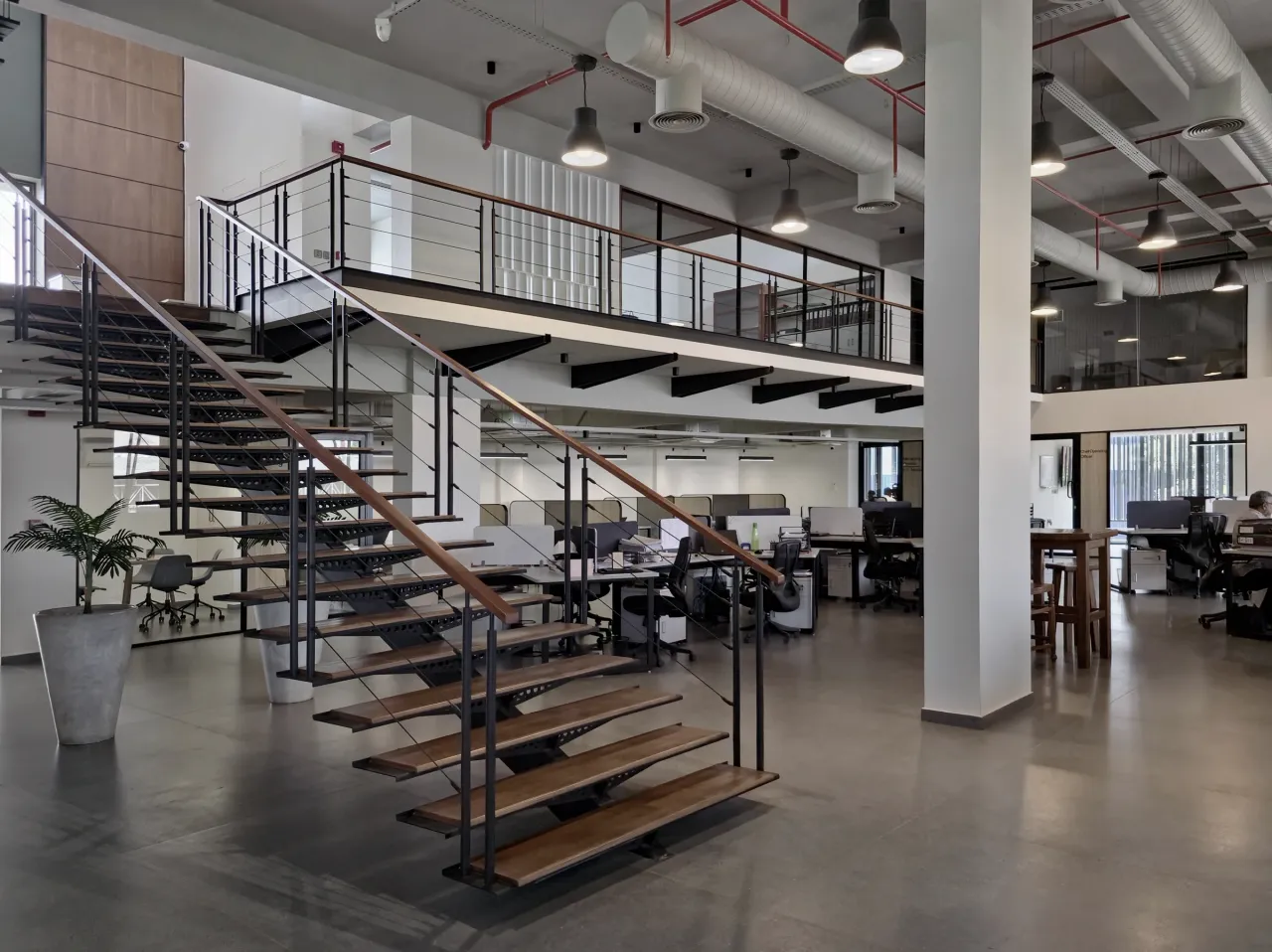 Open office interior organised around a steel staircase
